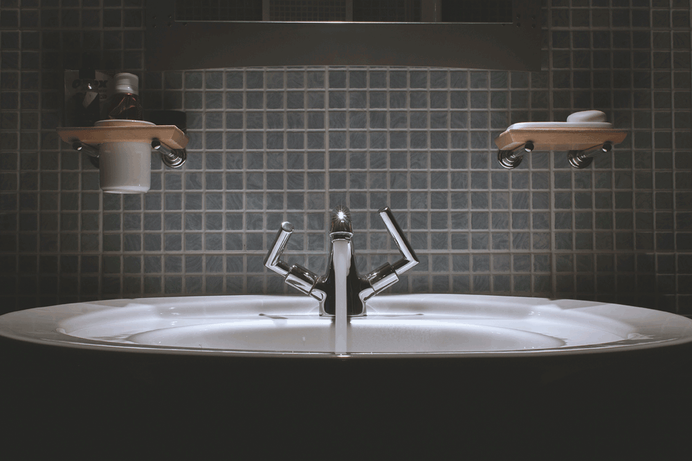 Picture of modern bathroom taps with atmospheric lighting