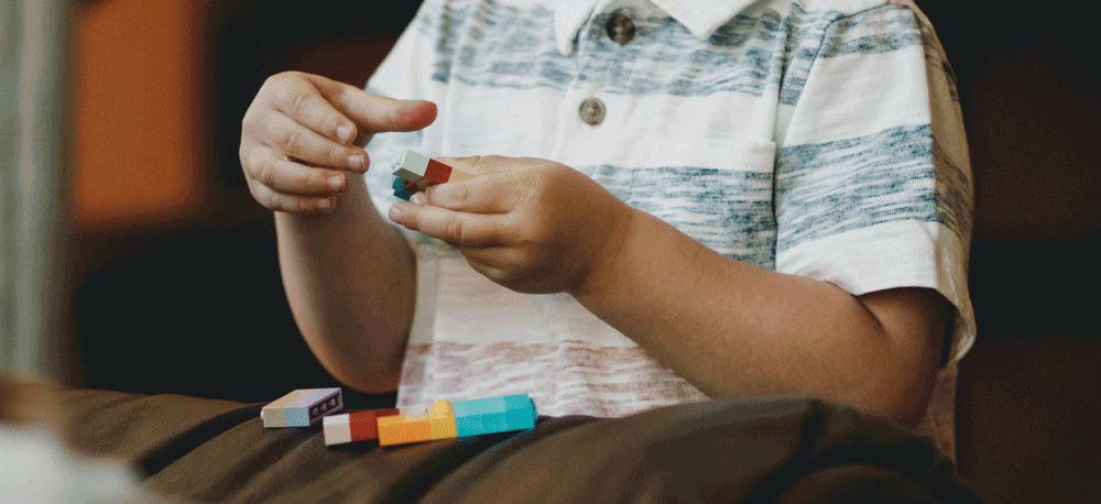 Picture of a boy playing with lego