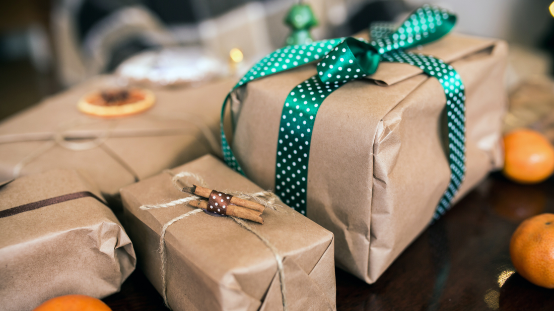 Picture of Christmas gifts in brown paper with green ribbon