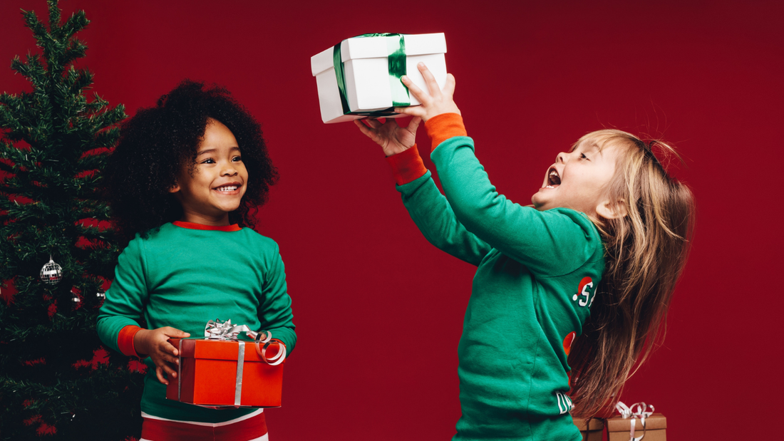 Picture of 2 children holding Christmas gifts
