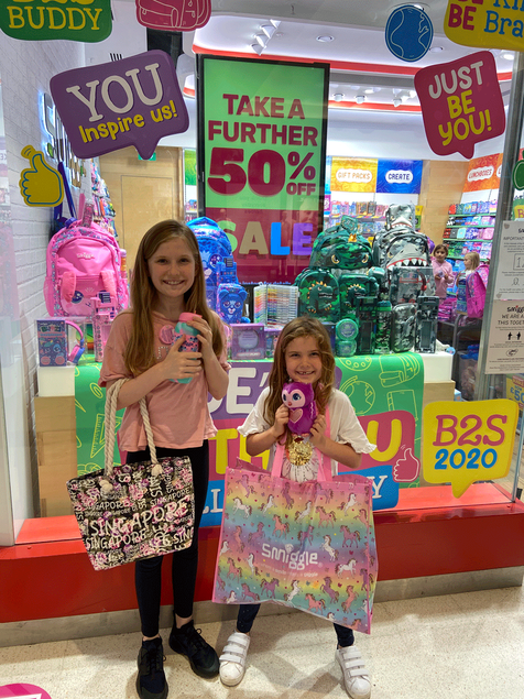 Picture of girls standing outside smiggle store with smiggle bag