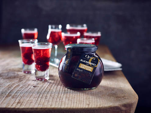 Picture of Opies fruit with alcohol, blackberries in gin on a wooden table