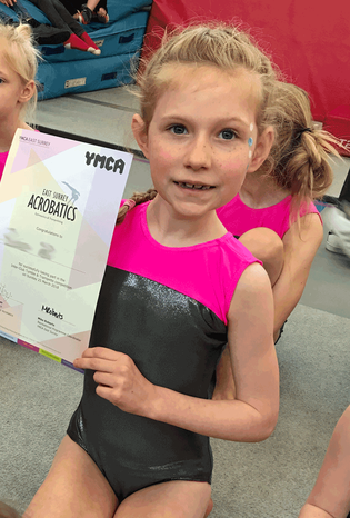 Picture of gymnast with certificate